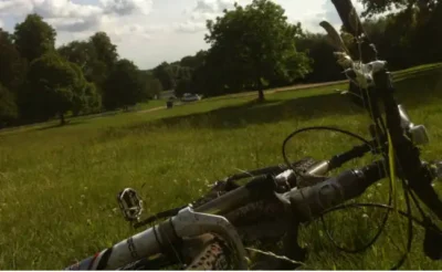 a bike lying in the grass after cycling with arthritis 
